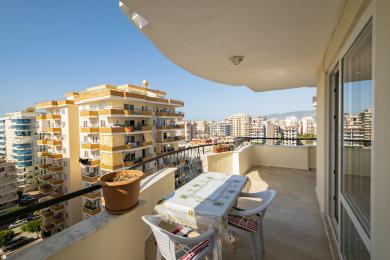 Alanya property balcony with city views, tile flooring, and bright, sunny atmosphere.