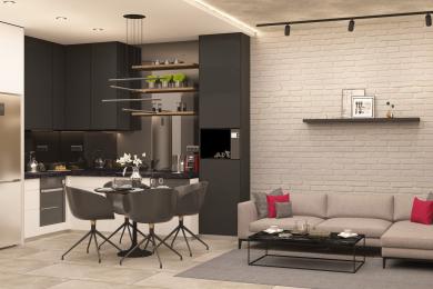 Bucătăria modernă open-space și zona de living din acest apartament din Alanya au dulapuri negre elegante, un perete de cărămidă și iluminat elegant.